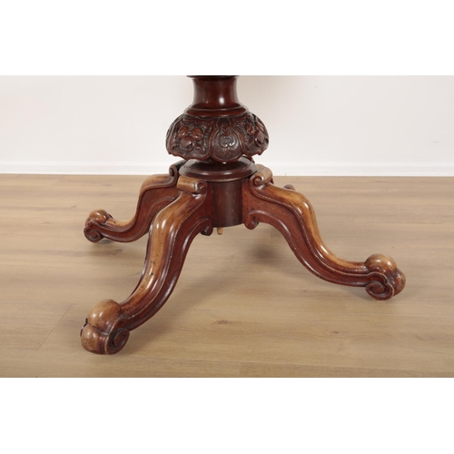 848 - A VICTORIAN MAHOGANY BREAKFAST TABLE the oval tilt top on a turned and heavily carved stem, to cabri... 