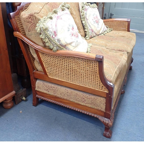 867 - A MAHOGANY FRAMED BERGERE SOFA two seat, with (intact) double-caned panels 137cm wide