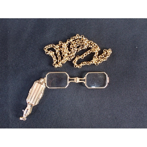 516 - A VINTAGE FOLDING LORGNETTE PENDANT in chased gold, geometric design with engine turned and engraved... 