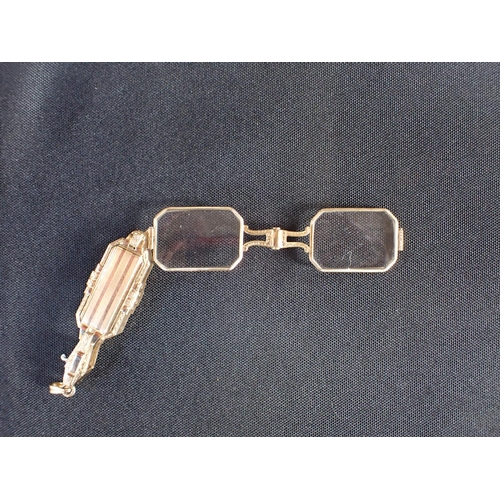 516 - A VINTAGE FOLDING LORGNETTE PENDANT in chased gold, geometric design with engine turned and engraved... 