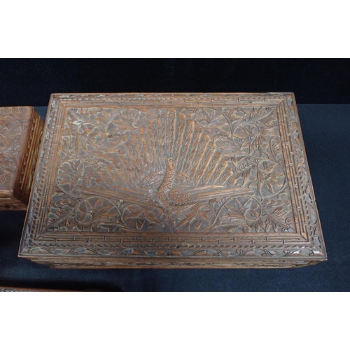 39 - A GROUP OF CARVED HARDWOOD BOXES an inkstand and a cigarette case, most with similar Peacock motif, ... 