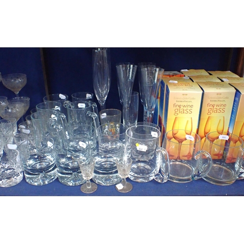 49 - A COLLECTION OF GLASSWARE, INCLUDING CHAMPAGNE GLASSES with etched and cut designs, modern tumblers ... 