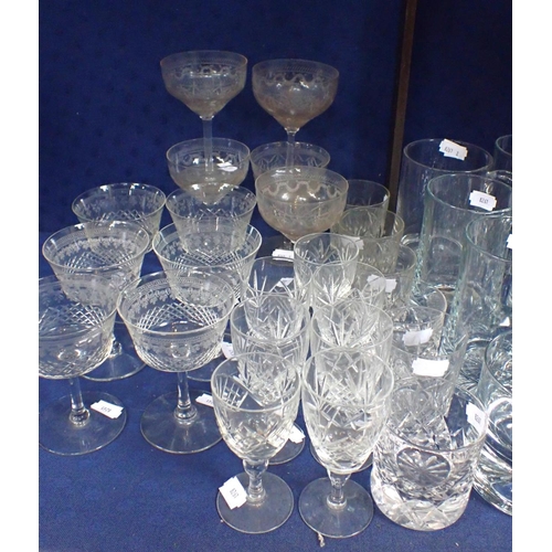 49 - A COLLECTION OF GLASSWARE, INCLUDING CHAMPAGNE GLASSES with etched and cut designs, modern tumblers ... 