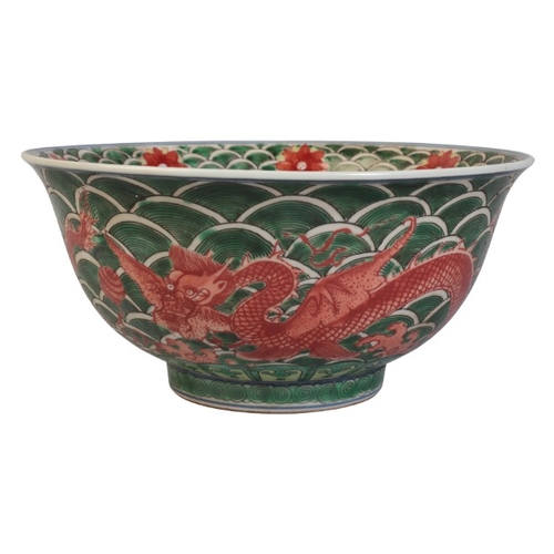 100 - A CHINESE FAMILLE VERTE DRAGON BOWL

bearing a Qianlong mark, 18th century or later, with writhing d... 