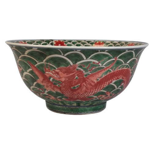 100 - A CHINESE FAMILLE VERTE DRAGON BOWL

bearing a Qianlong mark, 18th century or later, with writhing d... 