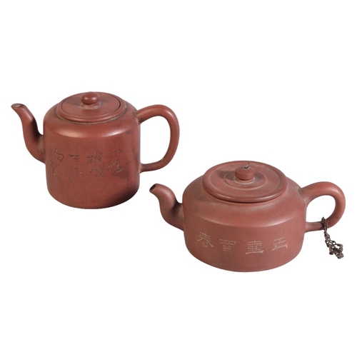 126 - TWO SIMILAR CHINESE YIXING TEAPOTS

one example with incised floral decoration to one side and scrip... 