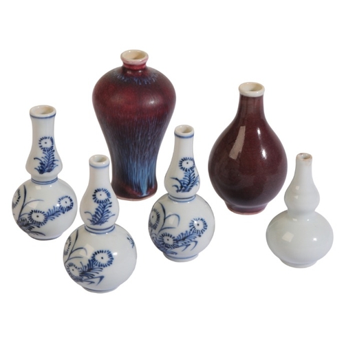 130 - A GROUP OF SIX CHINESE MINIATURE VASES

including a group of three blue and white vases, 7cm high, a... 