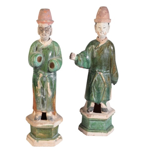 169 - TWO SIMILAR CHINESE SANCAI GLAZED GUARDIAN FIGURES

Ming Dynasty, figured with robes and high hats, ... 