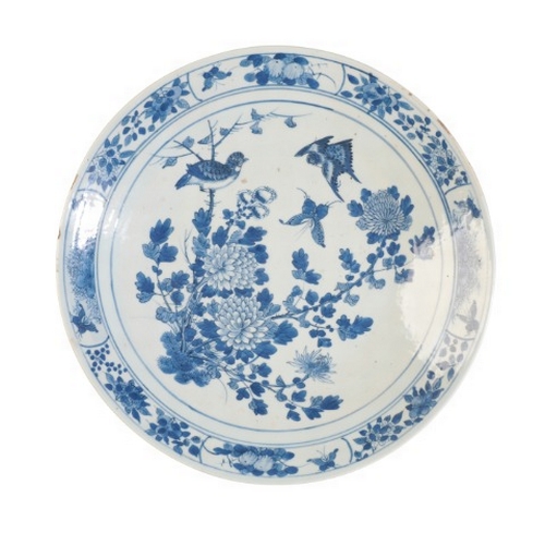 182 - A CHINESE BLUE AND WHITE CHARGER

19th century, decorated with birds and butterflies amongst chrysan... 