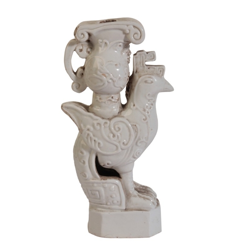 187 - A CHINESE BLANC DE CHINE CANDLESTICK

19th/20th century, modelled as a chicken with archaistic jug a... 