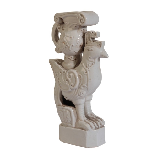 187 - A CHINESE BLANC DE CHINE CANDLESTICK

19th/20th century, modelled as a chicken with archaistic jug a... 