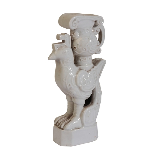 187 - A CHINESE BLANC DE CHINE CANDLESTICK

19th/20th century, modelled as a chicken with archaistic jug a... 