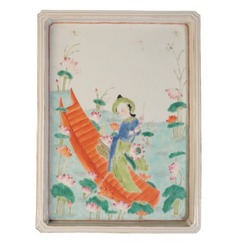 204 - A CHINESE FAMILLE ROSE PLAQUE

Qing or later, depicting a maiden in a boat harvesting lotus flowers ... 