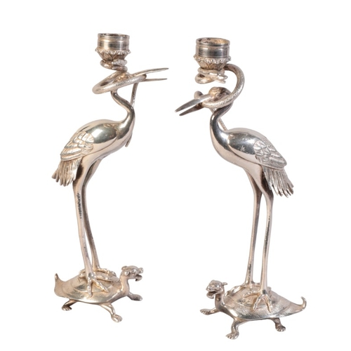 219 - A PAIR OF JAPANESE SILVERED METAL FIGURAL CANDLESTICKS

early 20th century, modelled as herons stand... 