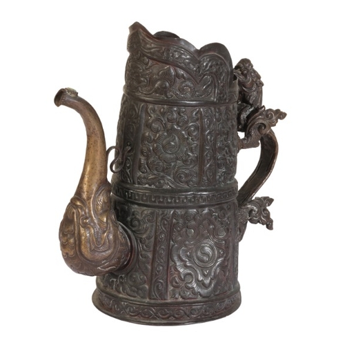 260 - A TIBETAN BRONZE CEREMONIAL EWER

19th century, the tapered repousse work body decorated with foliat... 