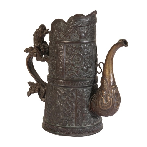 260 - A TIBETAN BRONZE CEREMONIAL EWER

19th century, the tapered repousse work body decorated with foliat... 