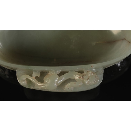 32 - A CHINESE CELADON JADE OVAL BOWL

with a chilong climbing along the projecting side handles, the bod... 