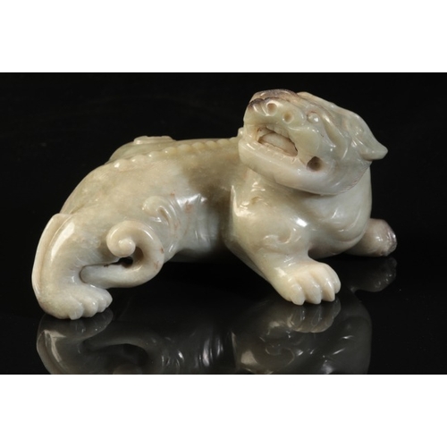 40 - A CHINESE CELADON JADE BUDDHISTIC LION

Qing or later, the beast with a well-defined spine and an op... 