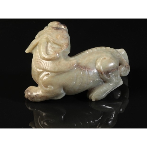 40 - A CHINESE CELADON JADE BUDDHISTIC LION

Qing or later, the beast with a well-defined spine and an op... 