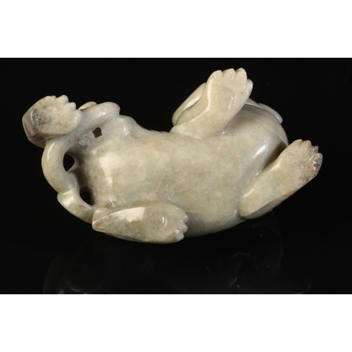 40 - A CHINESE CELADON JADE BUDDHISTIC LION

Qing or later, the beast with a well-defined spine and an op... 