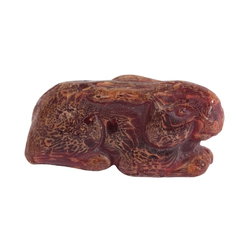 50 - A CHINESE AMBER RABBIT

late 19th/early 20th century, carved naturistically with ears back, 7cm long