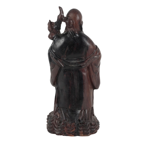 52 - A CHINESE CARVED HARDWOOD FIGURE OF SHOULAO

Qing dynasty, early 20th Century, 39cm high