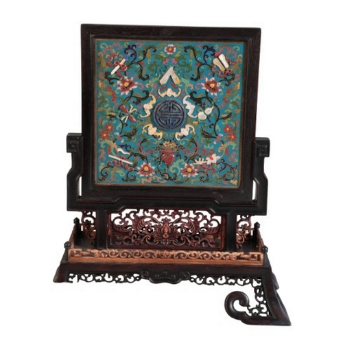 55 - A CHINESE HARDWOOD TABLE SCREEN

inset to one side with a cloisonnÃ© panel inlaid with a central sho... 