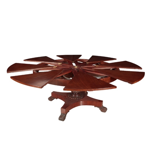 185 - A MAHOGANY CIRCULAR EXTENDING DINING TABLE OF JUPE TYPE

the top of eight triangular sections, on a ... 