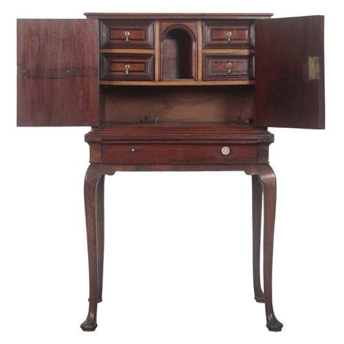 193 - A DUTCH WALNUT AND EBONY INLAID CABINET ON STAND

18th century and later, the upper section with cup... 