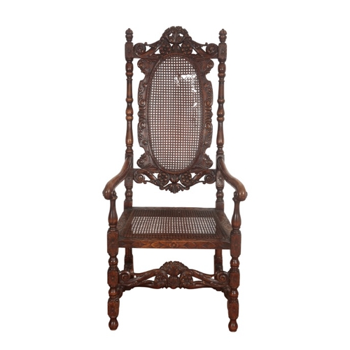 233 - A CHARLES II WALNUT ARMCHAIR

the cresting carved with two reclining putto, over a caned back and se... 