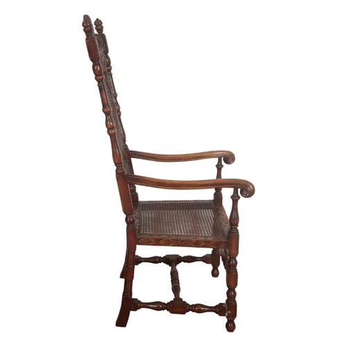 233 - A CHARLES II WALNUT ARMCHAIR

the cresting carved with two reclining putto, over a caned back and se... 