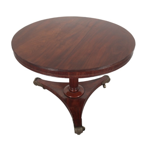 238 - A LATE REGENCY MAHOGANY CENTRE TABLE

the circular tilt-top with fluted edges, on a reeded stem to a... 