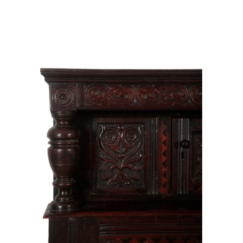 240 - A PANELLED OAK COURT CUPBOARD

17th century and later, with scroll carved frieze and inlaid with par... 