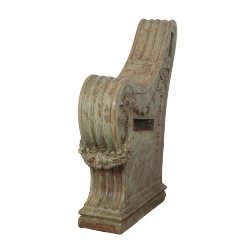 319 - A GREEN-PAINTED TERRACOTTA GARDEN BENCH

each of the scrolled ends moulded with floral swags and tra... 