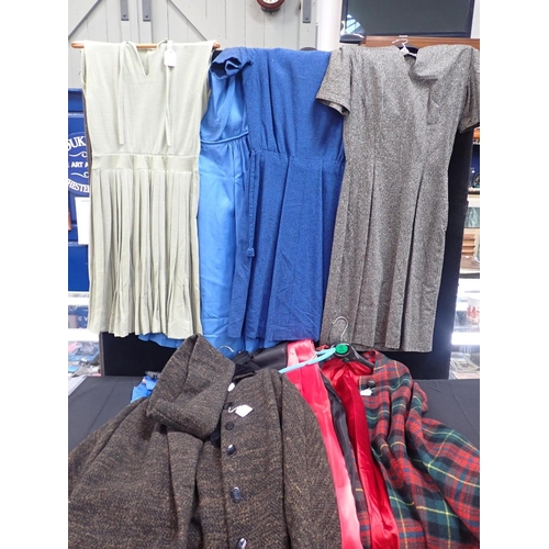 127 - A TARTAN WOOL CAPE with a quantity of vintage womens' dresses, mostly home made