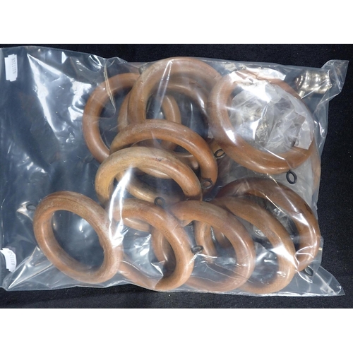 140 - A WOODEN CURTAIN POLE 175 cms long, with wooden curtain rings