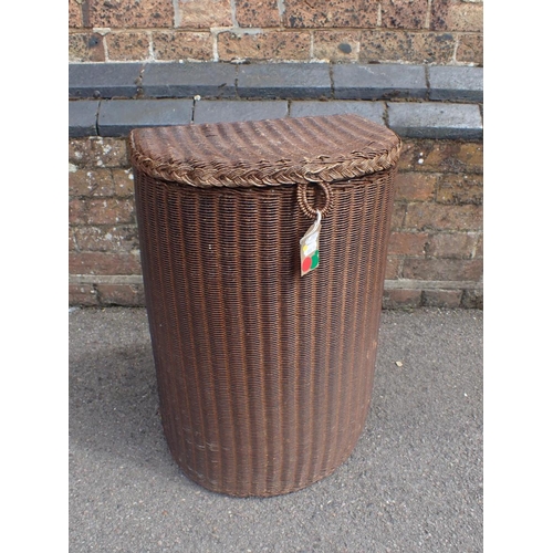 141 - A WOVEN LLOYD LOOM STYLE LAUNDRY BASKET (no label) 39cm wide