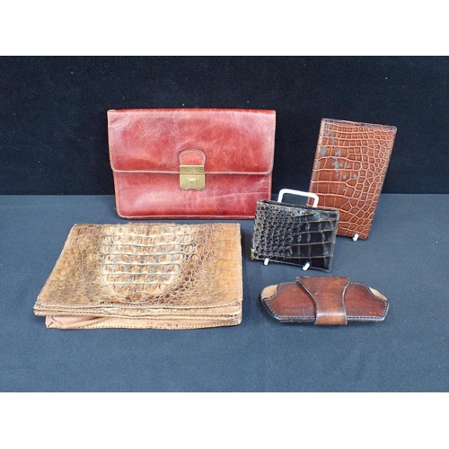 142 - A TAN LEATHER COMPARTMENTED CLUTCH BAG with another crocodie skin clutch bag, a leather sunglasses h... 