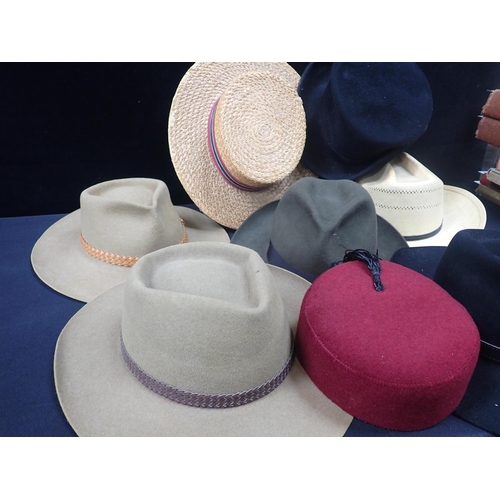 157 - AN AKUBRA FELT HAT with another and other hats including a girls school boater, a fez and a straw ha... 