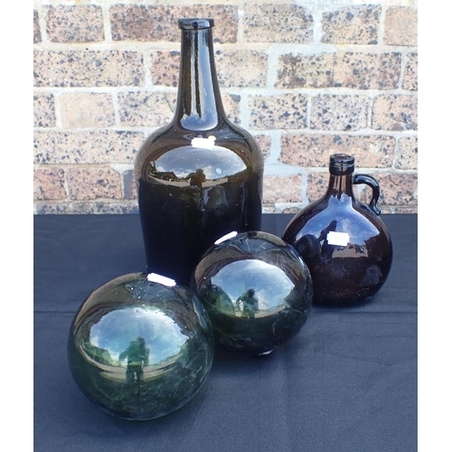 170 - A LARGE BROWN GLASS WINE BOTTLE, A FLASK and two green glass fishing floats