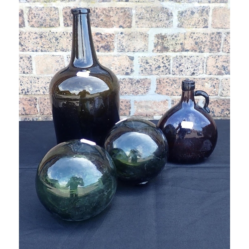 170 - A LARGE BROWN GLASS WINE BOTTLE, A FLASK and two green glass fishing floats
