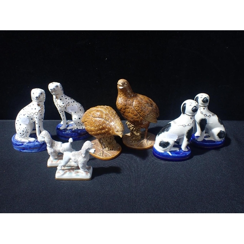 172 - A PAIR OF STAFFORDSHIRE DALMATIONS with a pair of poodles, and other animal and bird models