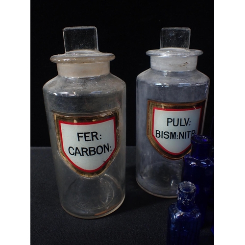 173 - A SET OF GLASS APOTHECARY JARS WITH INLAID LABELS tallest 21cms, and a quantity of blue glass medici... 