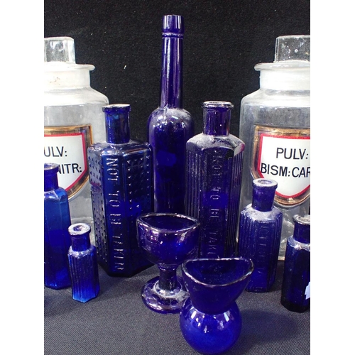 173 - A SET OF GLASS APOTHECARY JARS WITH INLAID LABELS tallest 21cms, and a quantity of blue glass medici... 