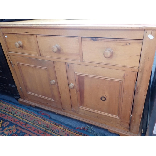961 - A VICTORIAN STYLE PINE SIDEBOARD OR DRESSER with three drawers over two doors, reproduction, 121cm w... 