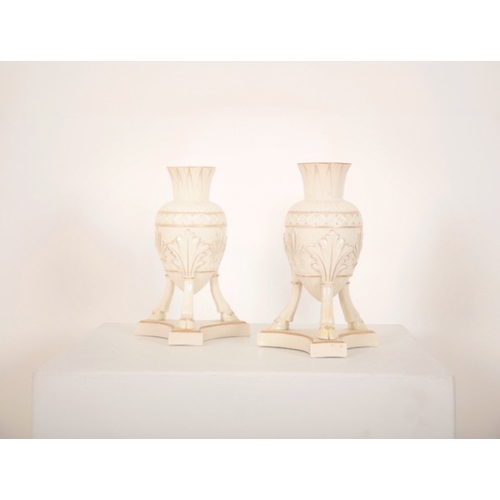 112 - A PAIR OF BELLEEK FIRST PERIOD PORCELAIN AMPHORA VASES

with gilt highlights, on three cloven hooves... 