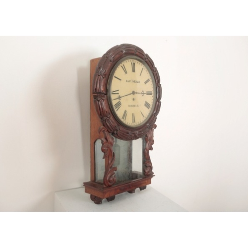 132 - A VICTORIAN WALL CLOCK BY 'ALF HEALD, WISBECH'

the circular dial surrounded by carved mahogany laur... 