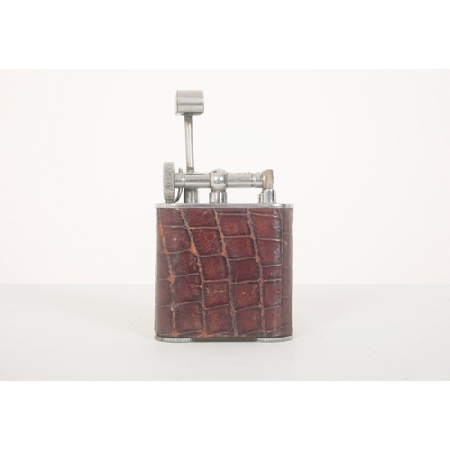 163 - TWO LIGHTERS WITH CROCODILE SKIN EXTERIORS

the first a table lighter with flip top lid and chrome f... 