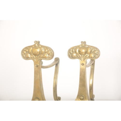 186 - A PAIR OF BRASS ARTS AND CRAFTS FIRE DOGS OR ANDIRONS

early 20th century, the stylised tree termina... 