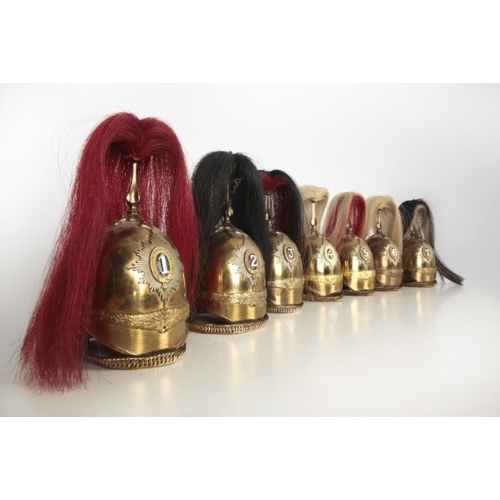 203 - SEVEN MODEL BRASS CAVALRY HELMETS WITH HORSEHAIR PLUMES

British Victorian 1871 Pattern style but la... 